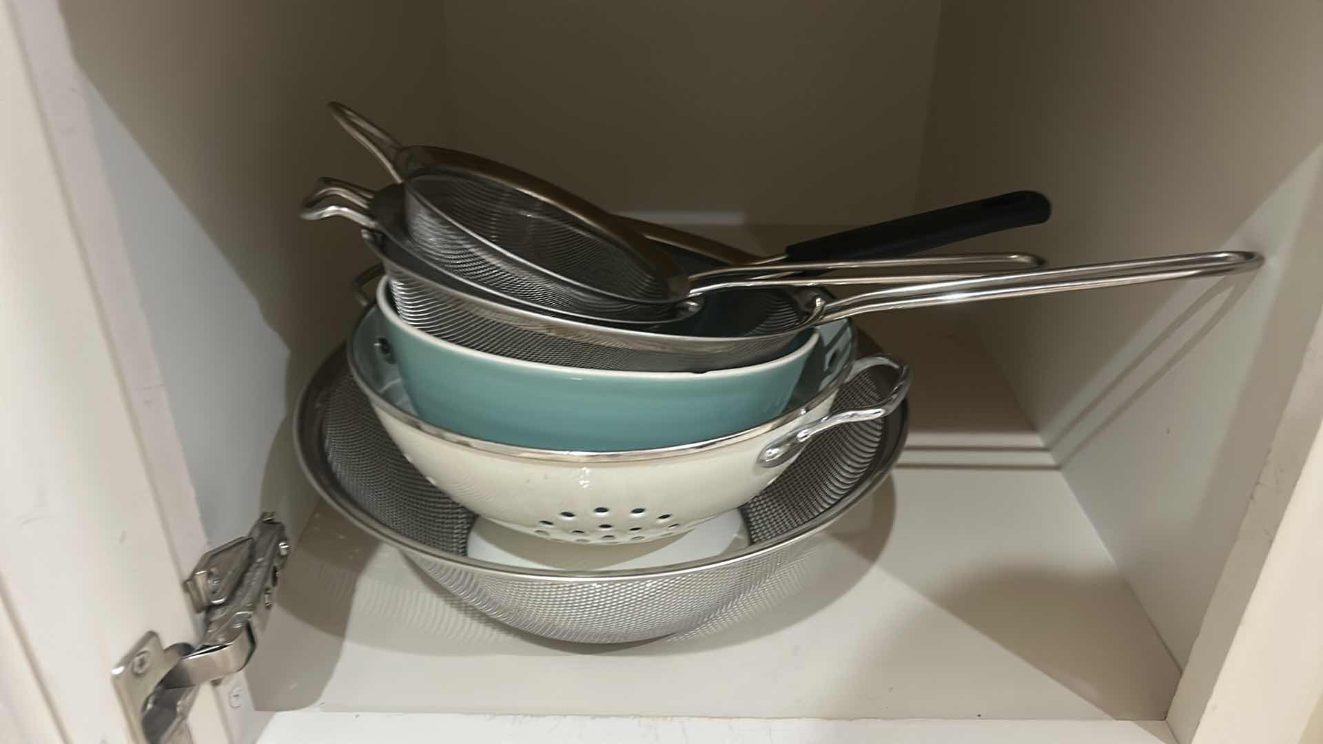 Photo 1 of CONTENTS OF CABINET IN KITCHEN PLATES, SALAD, SPINNER, COLANDERS, AND MORE