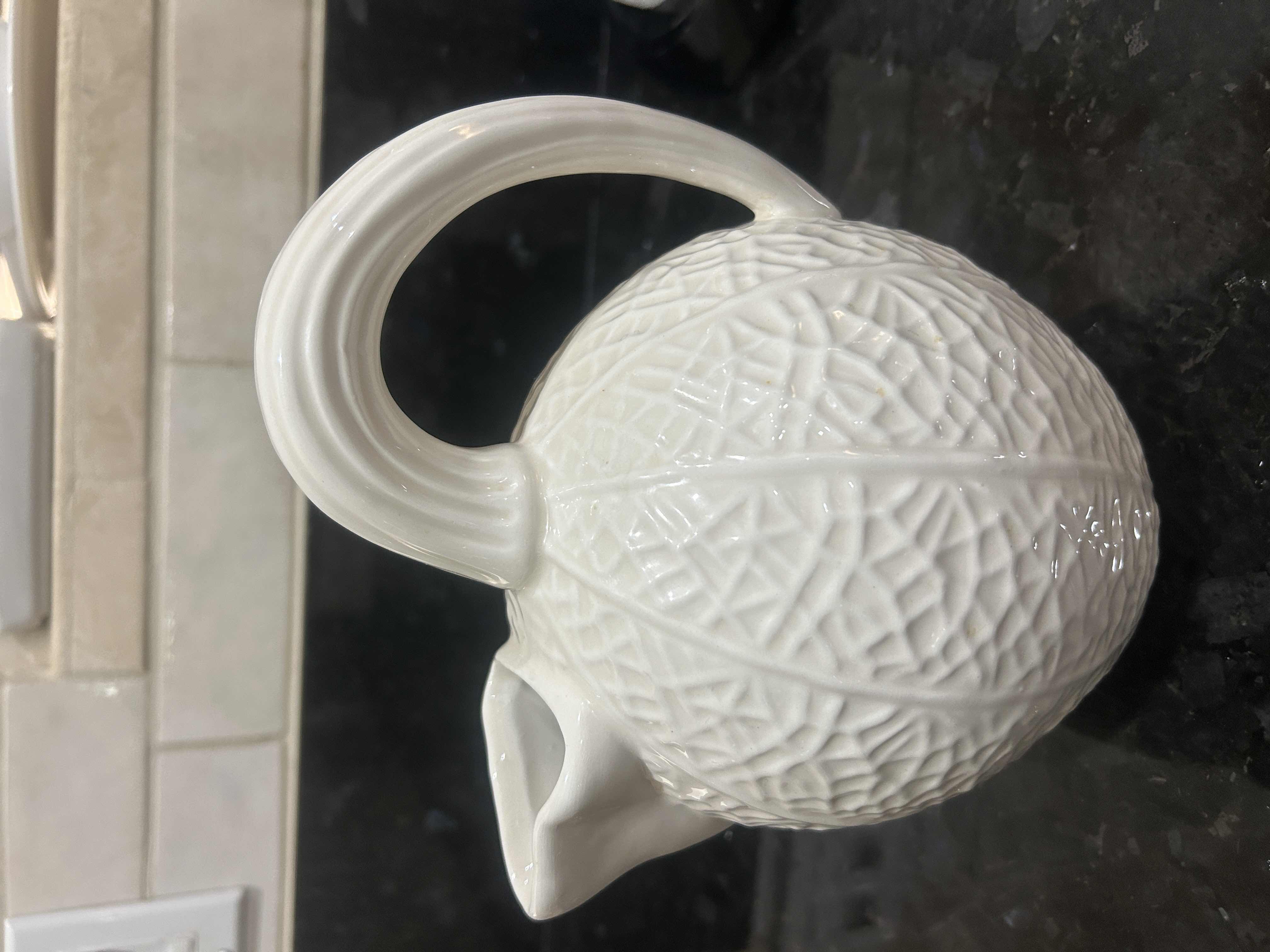 Photo 1 of BLOOMINGDALES WHITE CERAMIC PITCHER IS DESIGNED WITH A UNIQUE TEXTURED REPTILIAN PATTERN REMINISCENT OF A KAISER REPTILE PATTERN VASE.