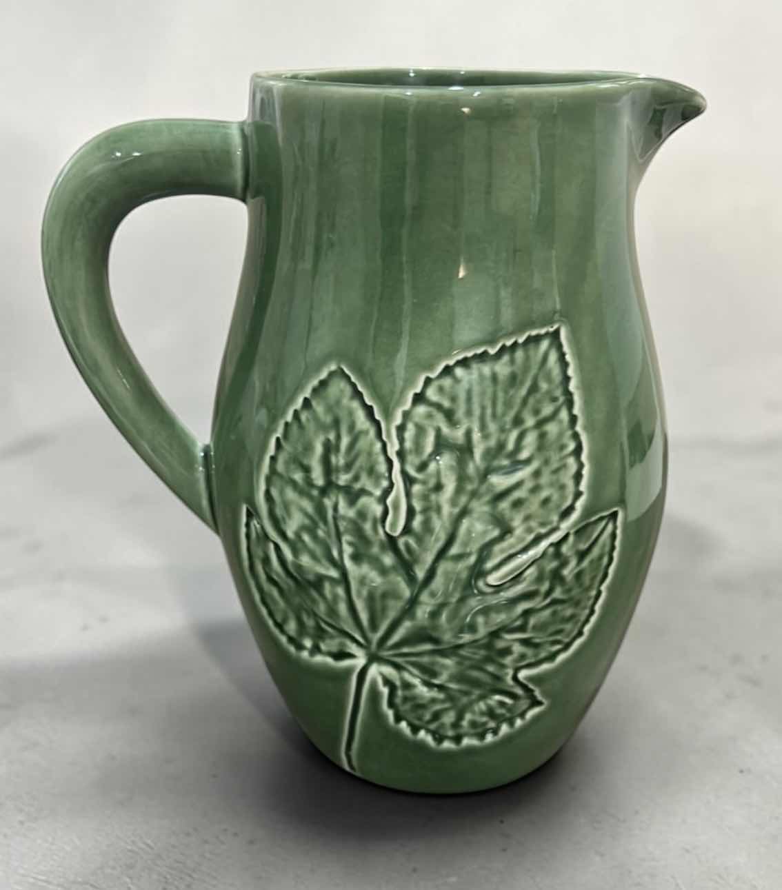Photo 1 of GREEN CERAMIC PITCHER IS A BORDALLO PINHEIRO MAJOLICA PIECE FROM PORTUGAL FEATURING AN EMBOSSED MAPLE LEAF DESIGN.