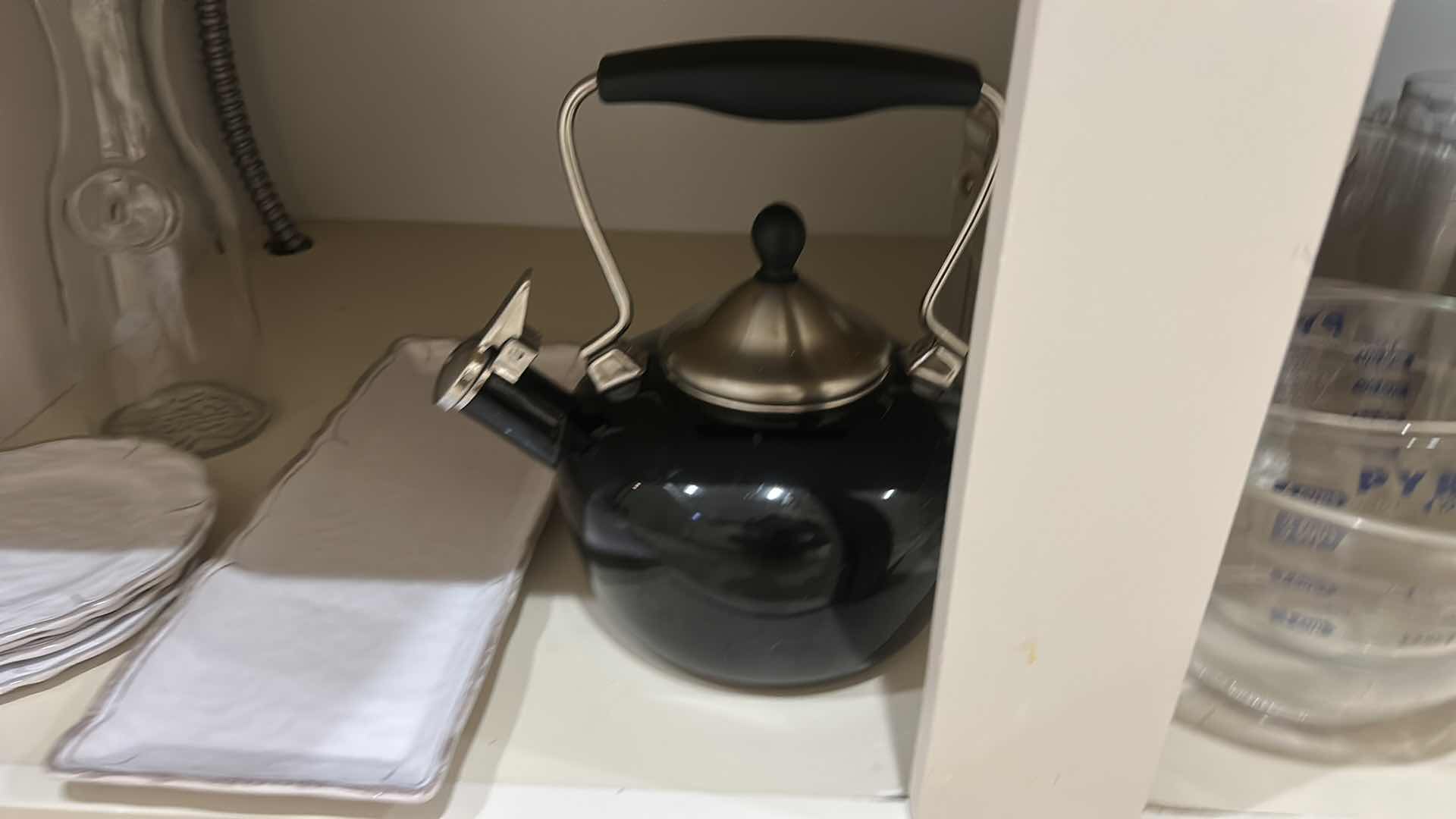 Photo 1 of CONTENTS OF KITCHEN CABINET, MEASURING ITEMS, SERVINGWARE, TEAPOT, AND MORE