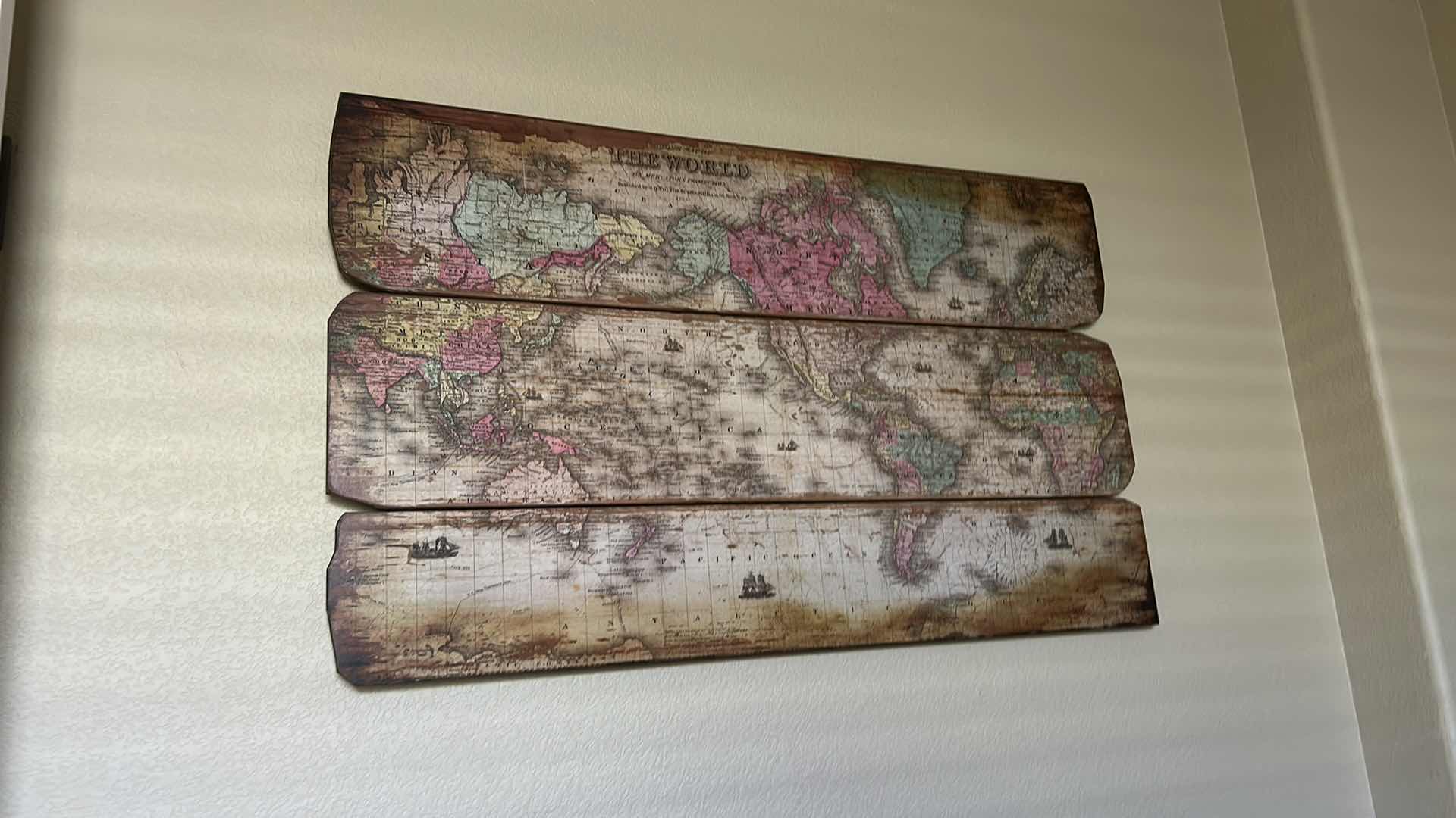 Photo 1 of VINTAGE-STYLE WORLD MAP ART PIECE IS SPLIT ACROSS THREE WEATHERED WOODEN BOARDS. 47” x H28 1/2” ARTWORK