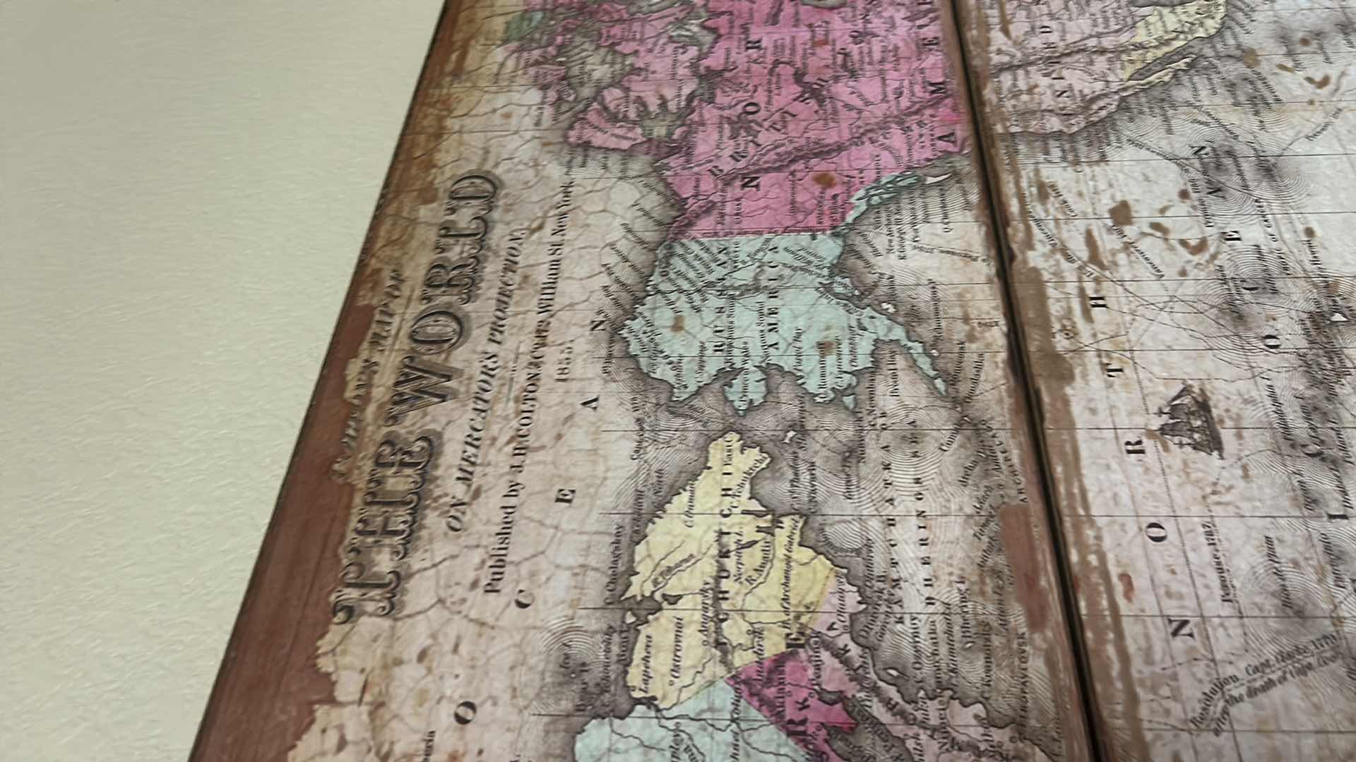 Photo 1 of VINTAGE-STYLE WORLD MAP ART PIECE IS SPLIT ACROSS THREE WEATHERED WOODEN BOARDS. 47” x H28 1/2” ARTWORK