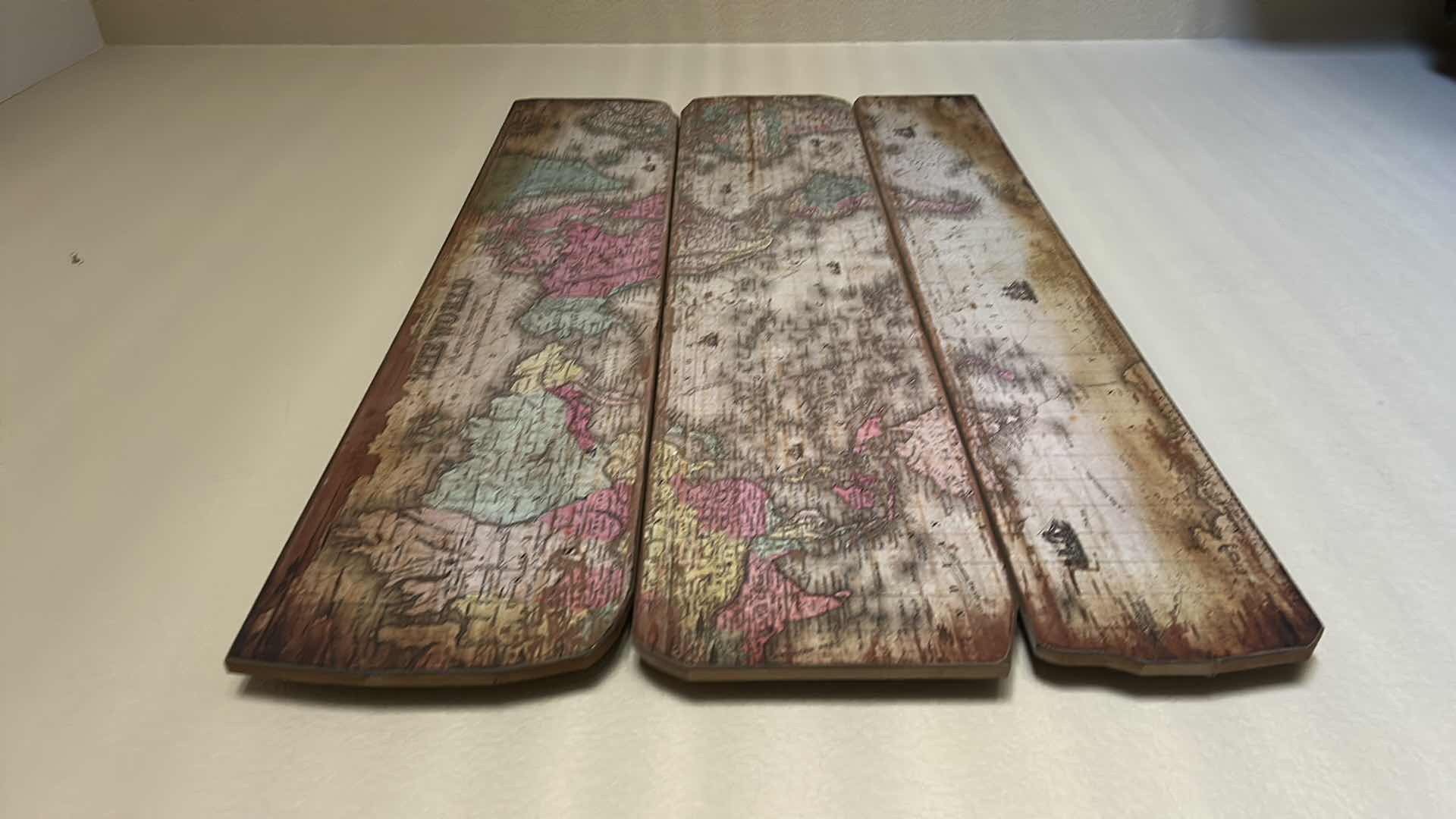 Photo 1 of VINTAGE-STYLE WORLD MAP ART PIECE IS SPLIT ACROSS THREE WEATHERED WOODEN BOARDS. 47” x H28 1/2” ARTWORK