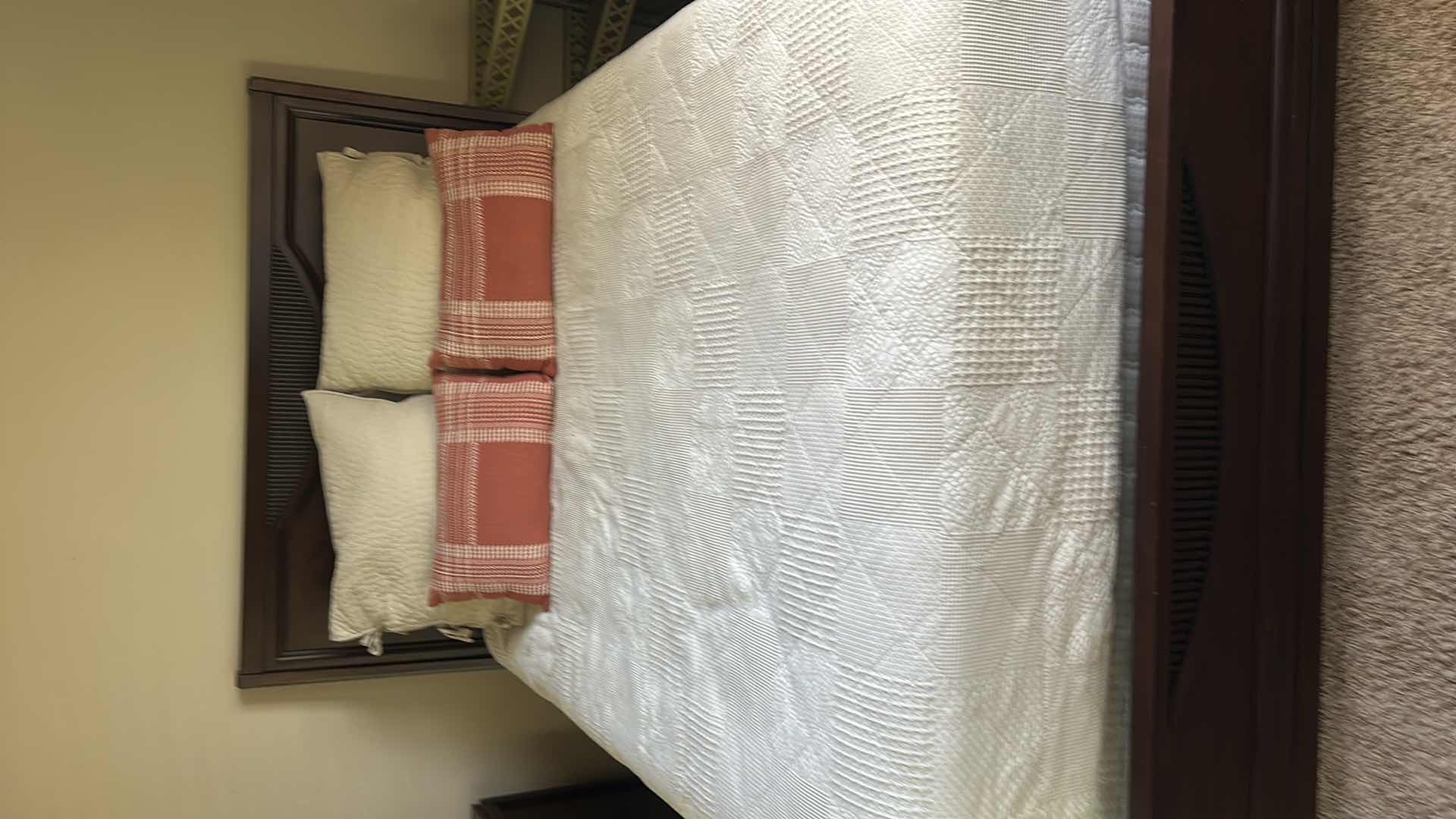 Photo 1 of DARK WOOD PLATFORM BED FEATURING A SLEIGH-STYLE HEADBOARD, MATCHING FOOTBOARD, AND NEUTRAL QUILTED BEDDING WITH ACCENT PILLOWS. INCLUDES SERTA QUEEN MATTRESS. (MATTRESS MEASURES 5 FEET X 81”  INCHES HEADBOARD HEIGHT 52 1/2 INCHES)