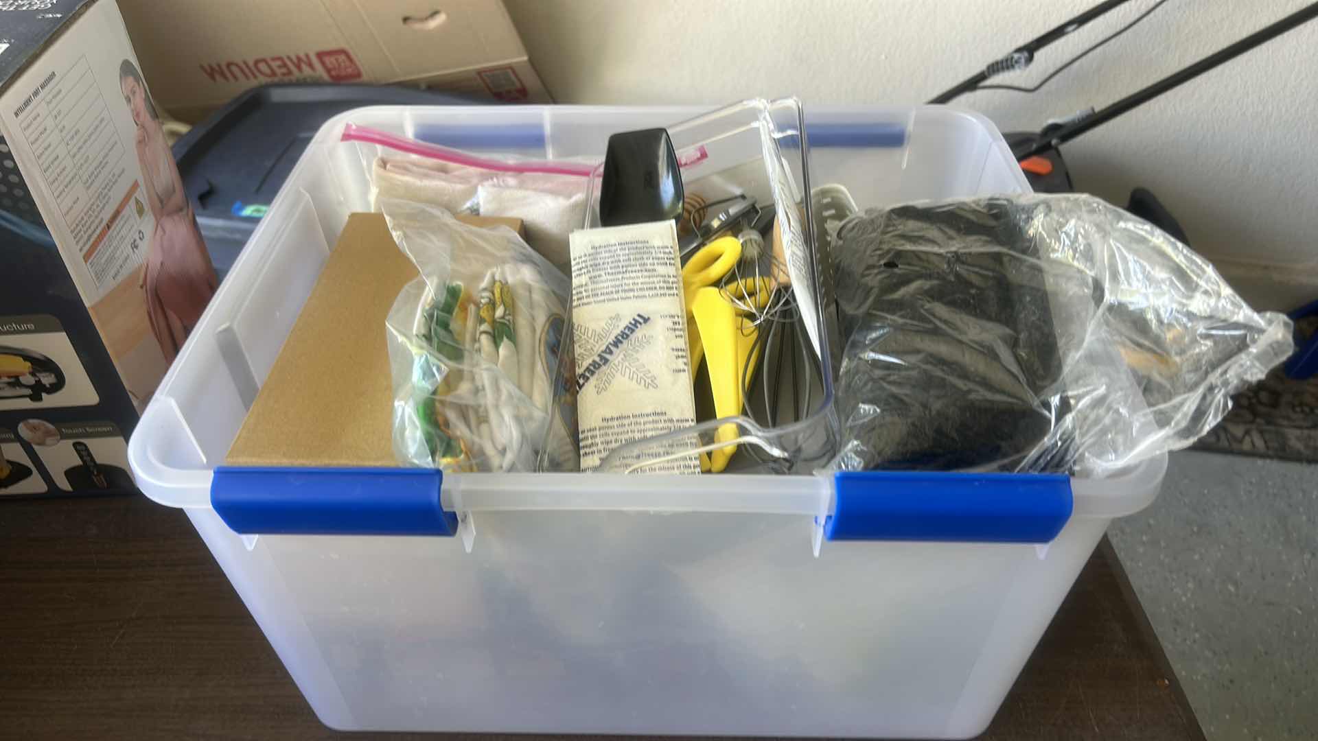 Photo 1 of ASSORTED CRAFT, SEWING, AND HOUSEHOLD SUPPLIES INCLUDING SCISSORS, THREAD, FABRIC, CORDS, CLIPS, AND SMALL TOOLS IN A PLASTIC STORAGE TOTE.