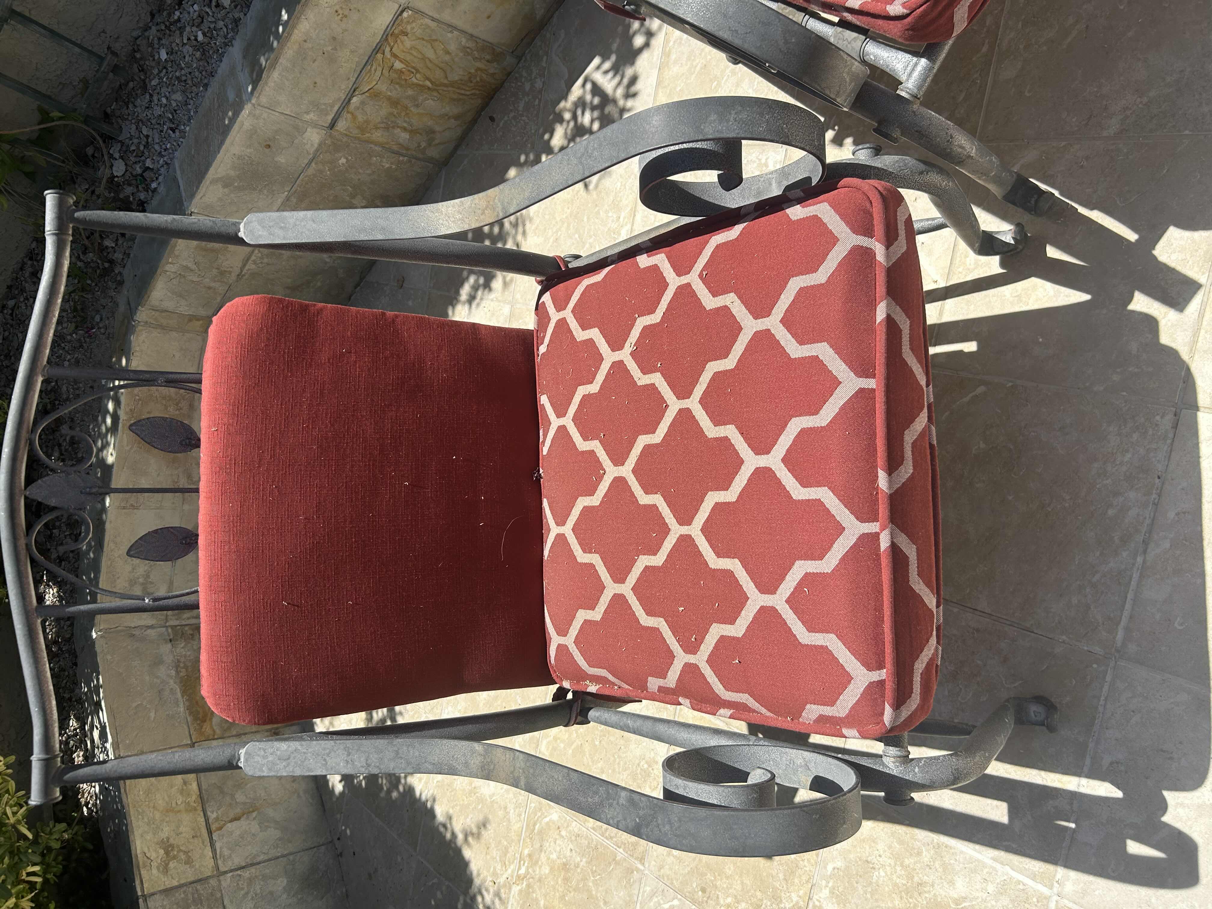 Photo 1 of RED GREY METAL OUT DOOR ARM CHAIR W GEOMETRIC TRELLIS PATTERN ON CUSHIONS