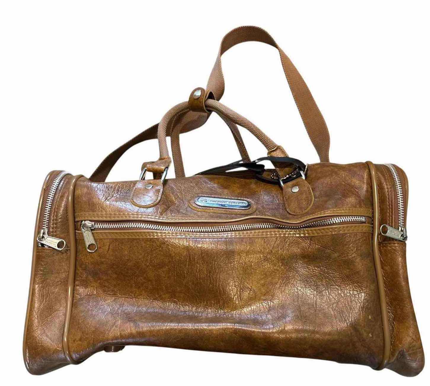 View 1 of VINTAGE AMERICAN TOURISTER BROWN FAUX LEATHER DUFFEL TRAVEL BAG WITH SHOULDER STRAP 16”X2”H10.5”