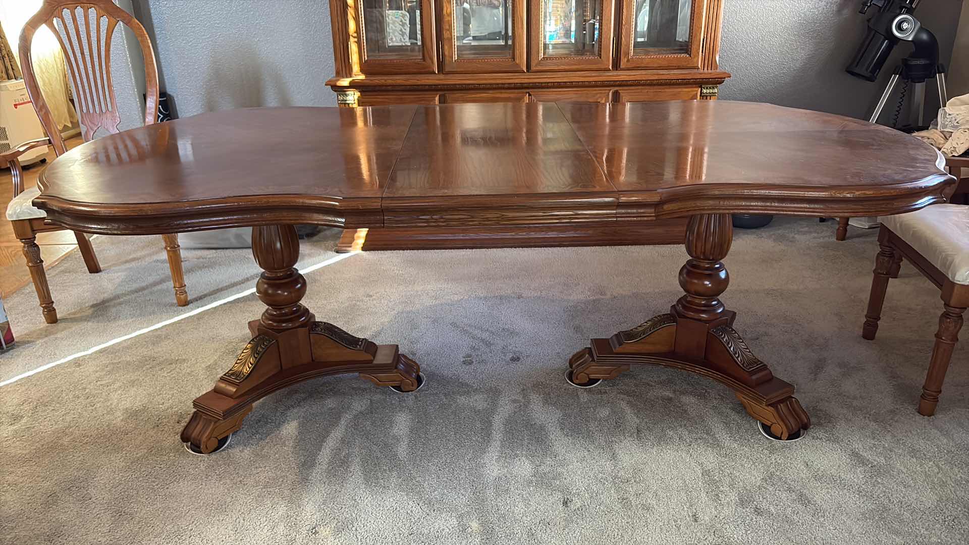 View 1 of TRADITIONAL WOOD EXTENDABLE DINING TABLE WITH ORNATE PEDESTAL BASE – MEDIUM BROWN COMES W/TWO EXTENSION LEAVES AND FELT COVERS 84”X62”H29.5”