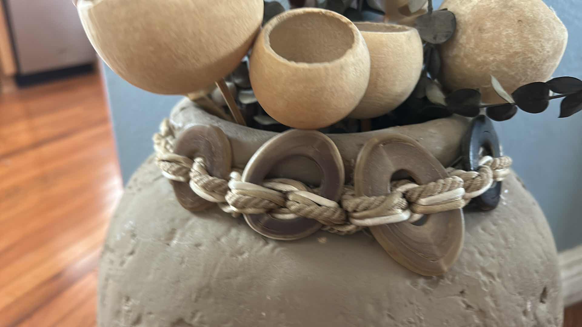 Photo 1 of TERRA-COTTA VASE FEATURING A RUSTIC URN SHAPE WITH A DECORATIVE BRAIDED ROPE, ACCENT AND FAUX FLOWERS H18”