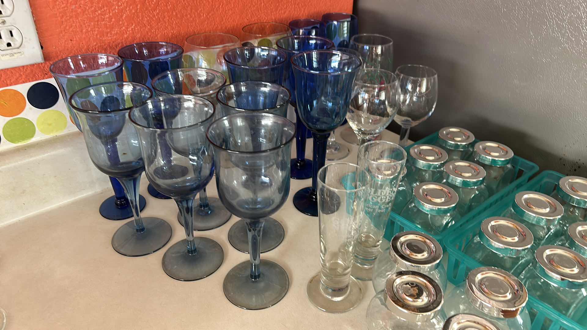 Photo 1 of COLLECTION FEATURING SEVERAL TYPES OF DRINKWARE, INCLUDING VINTAGE CRISTAR SKY BLUE RIOGA WINE, GLASSES AND STEMLESS, GOLDEN NUGGET BRANDED TUMBLERS ARE