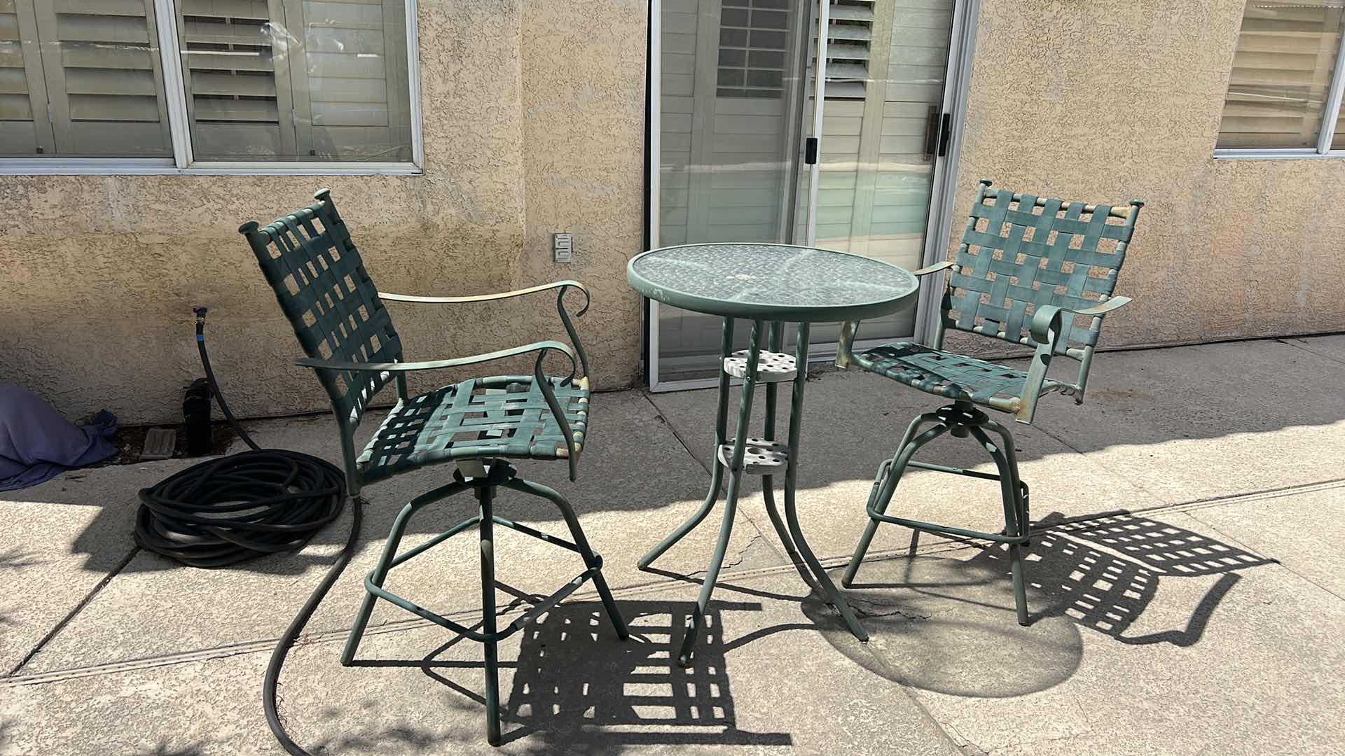 Photo 1 of METAL BAR HEIGHT OUTDOOR TABLE AND TWO CHAIRS WITH GREEN PATINA 28” X 28” X H 27 1/4” SEAT HEIGHT 26” OVERALL HEIGHT 43 1/2”