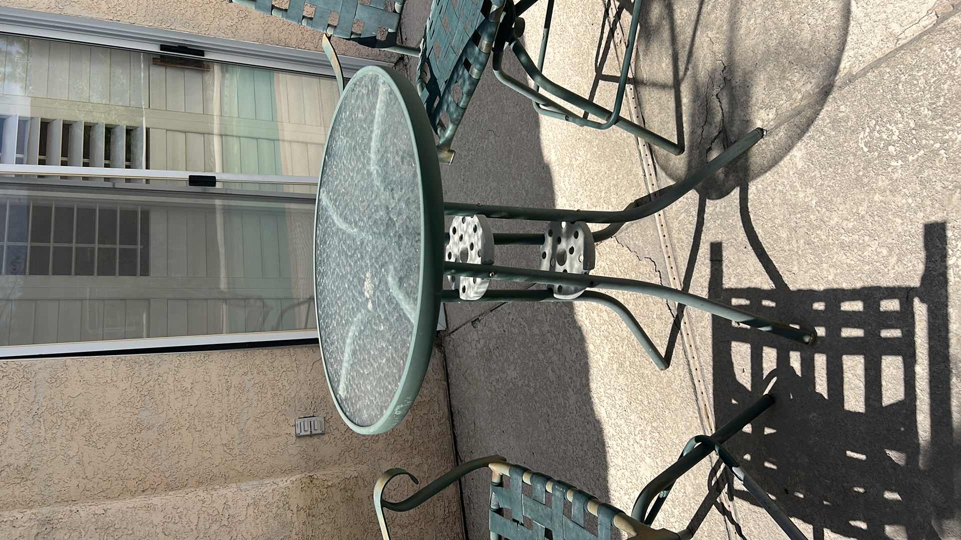 Photo 1 of METAL BAR HEIGHT OUTDOOR TABLE AND TWO CHAIRS WITH GREEN PATINA 28” X 28” X H 27 1/4” SEAT HEIGHT 26” OVERALL HEIGHT 43 1/2”