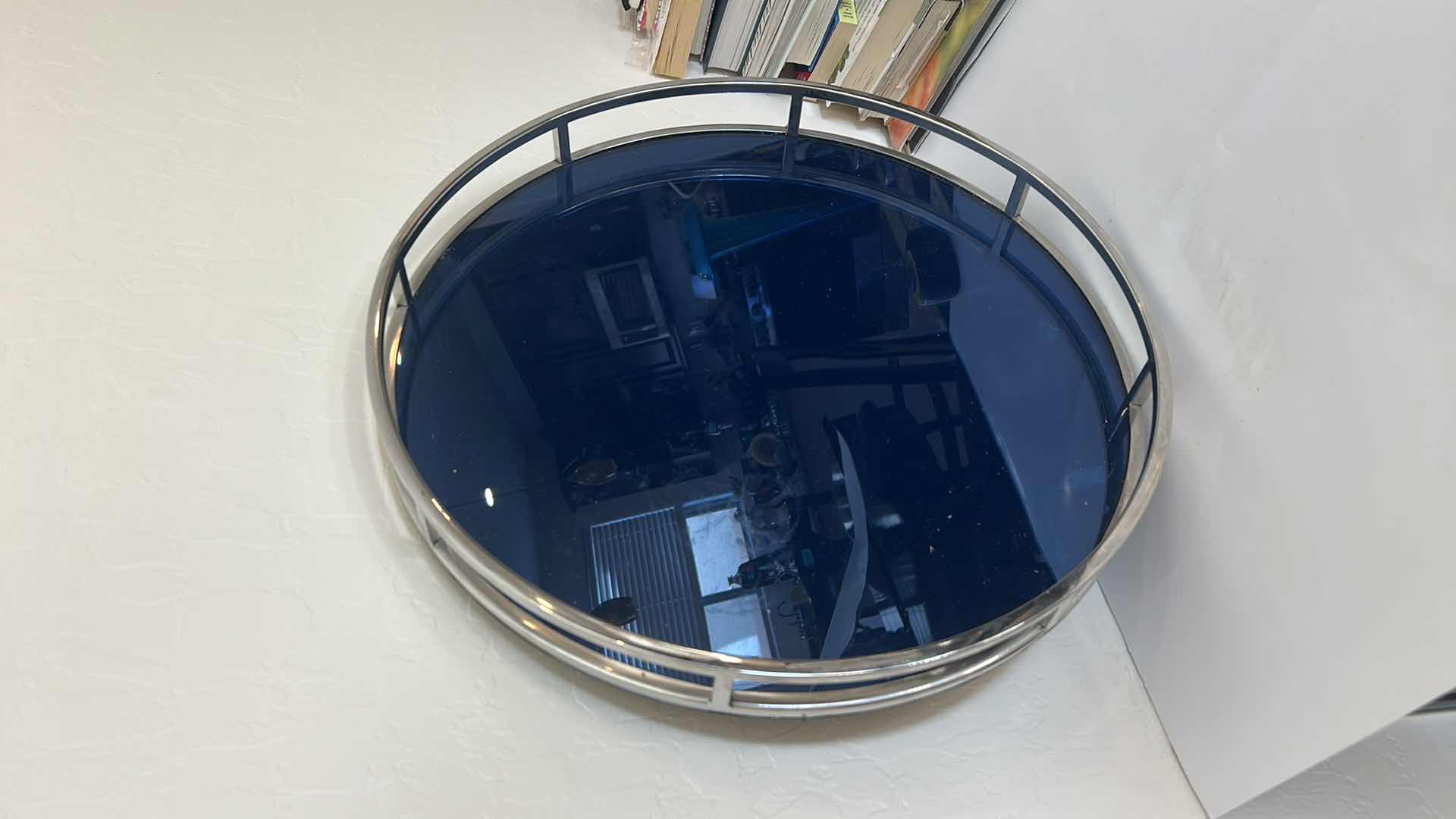 Photo 1 of ROUND TRAY FEATURING A SLEEK, SILVER TONED METAL RIM AND A DARK BLUE GLASS BOTTOM  21” x H2 1/2”