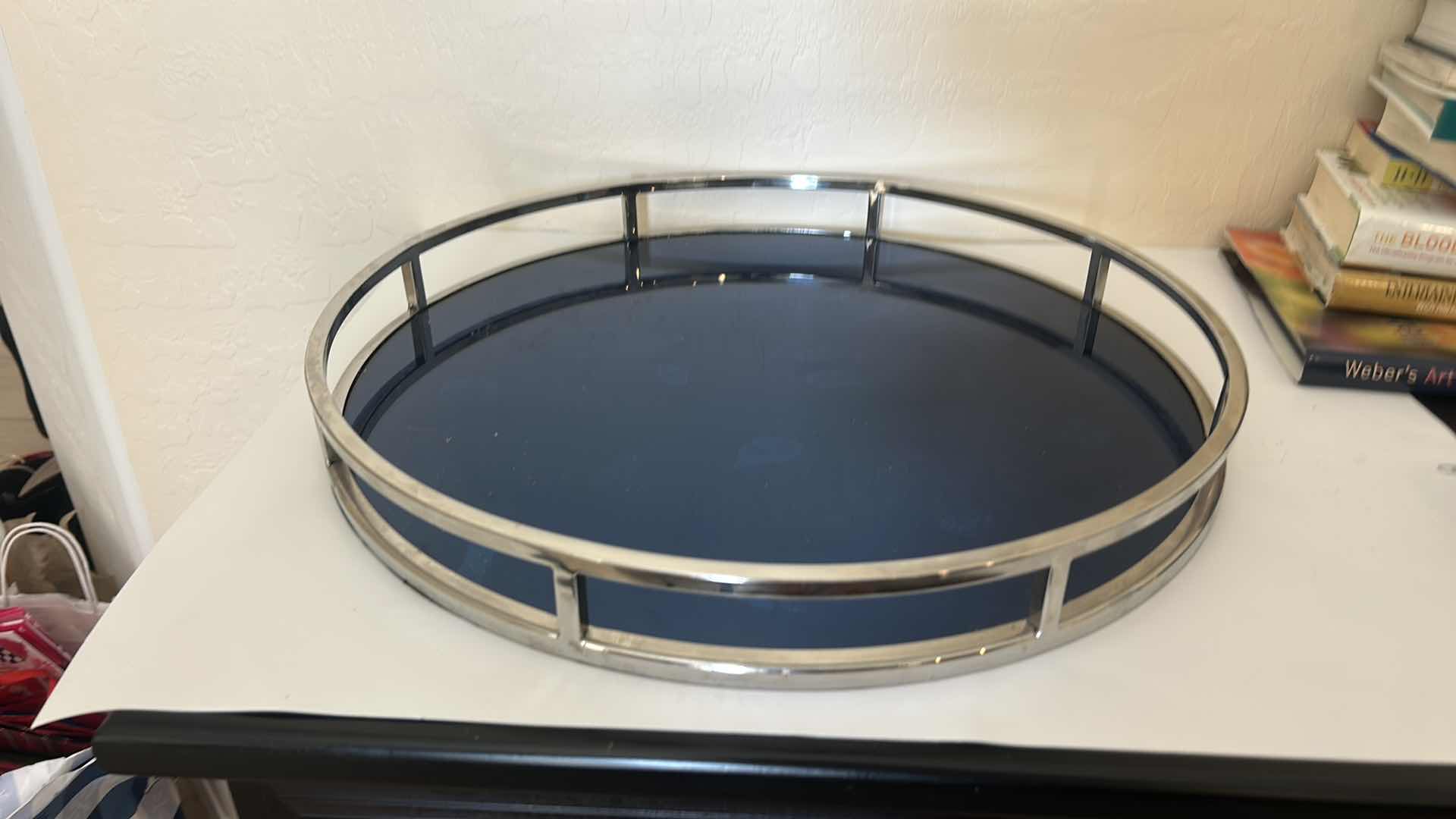 Photo 1 of ROUND TRAY FEATURING A SLEEK, SILVER TONED METAL RIM AND A DARK BLUE GLASS BOTTOM  21” x H2 1/2”