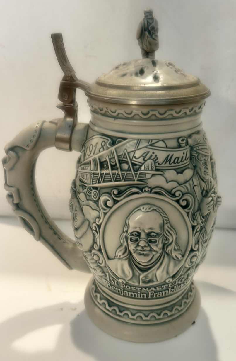 View 1 of AVON CERAMIC BEER STEIN, TITLED "SALUTE TO THE POSTAL SERVICE." H9.5”
