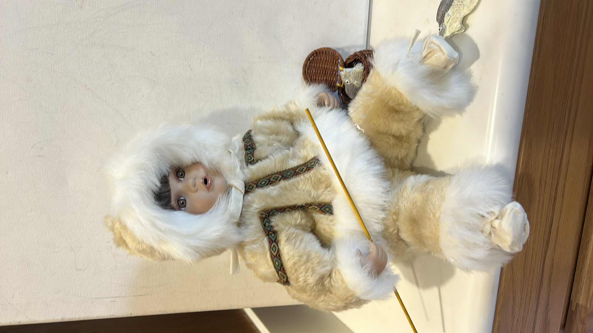 Photo 1 of VINTAGE PORCELAIN DOLL, TRADITIONAL INUIT WINTER PARKA W FISHING ROD & BASKET W FISH $60
