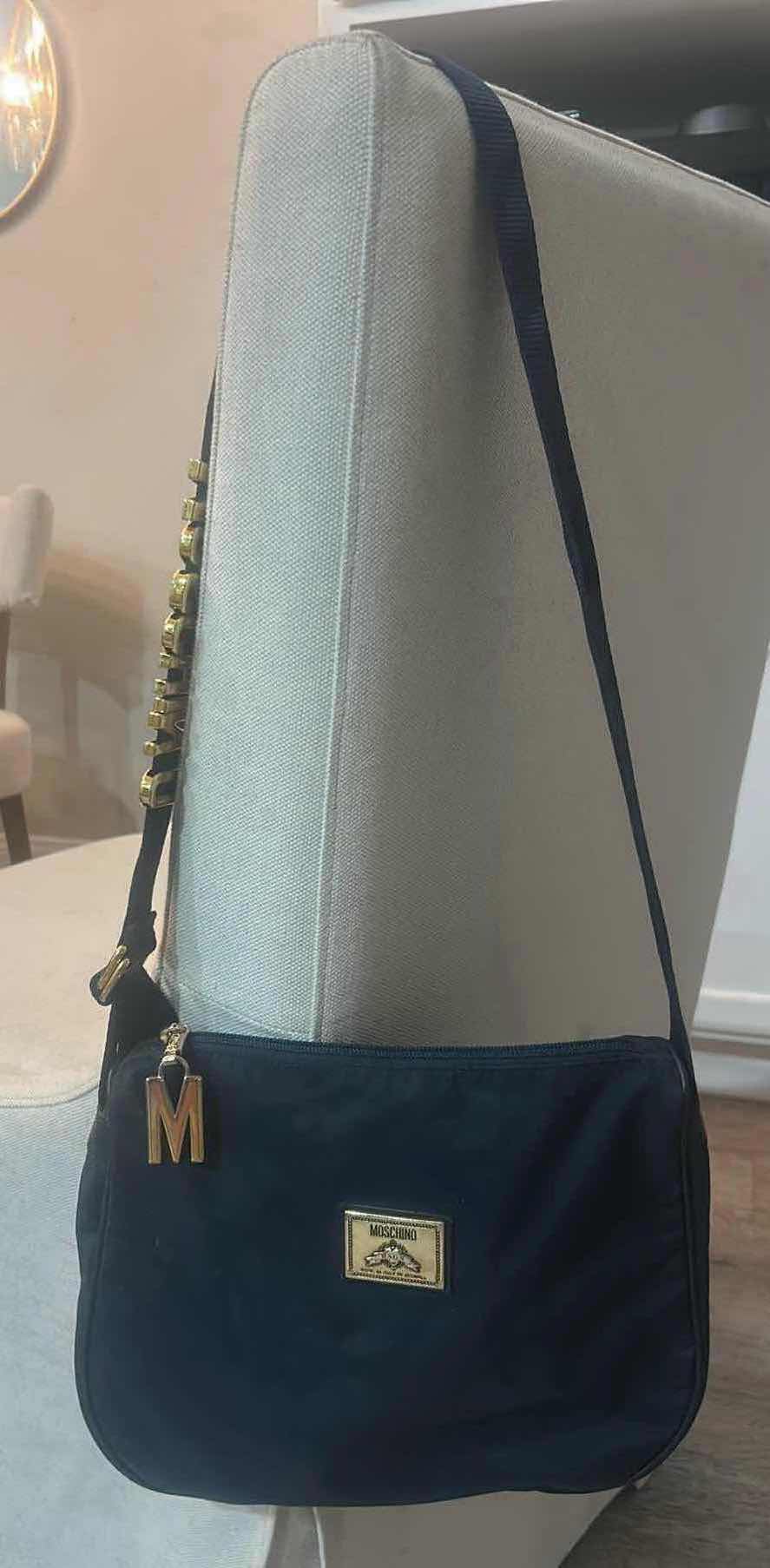 Photo 1 of VINTAGE BLACK NYLON MOSCHINO SHOULDER BAG WITH BRANDS SIGNATURE BLOCK LETTERING ALONG THE STRAP