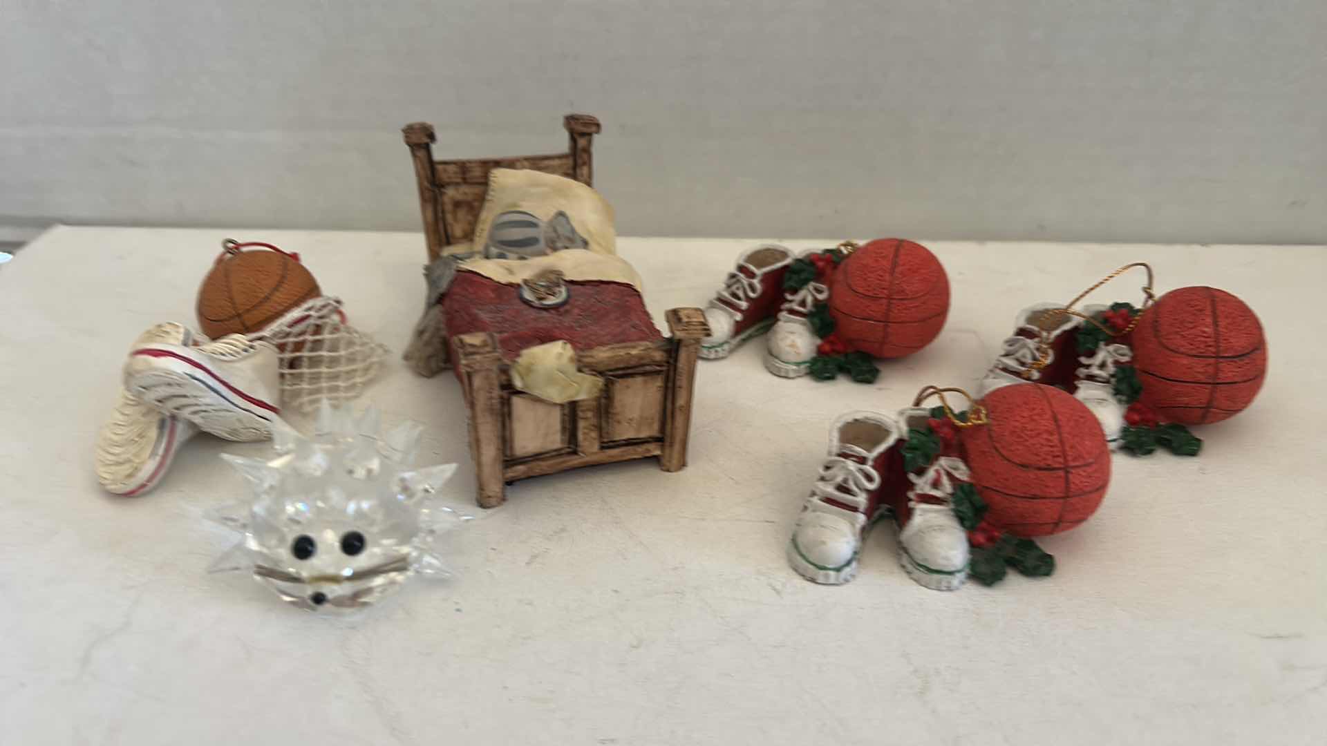 Photo 1 of FOUR BASKETBALL ORNAMENTS, GLASS, PORCUPINE & CERAMIC FIGURINE OF CAT IN BED H2.5”