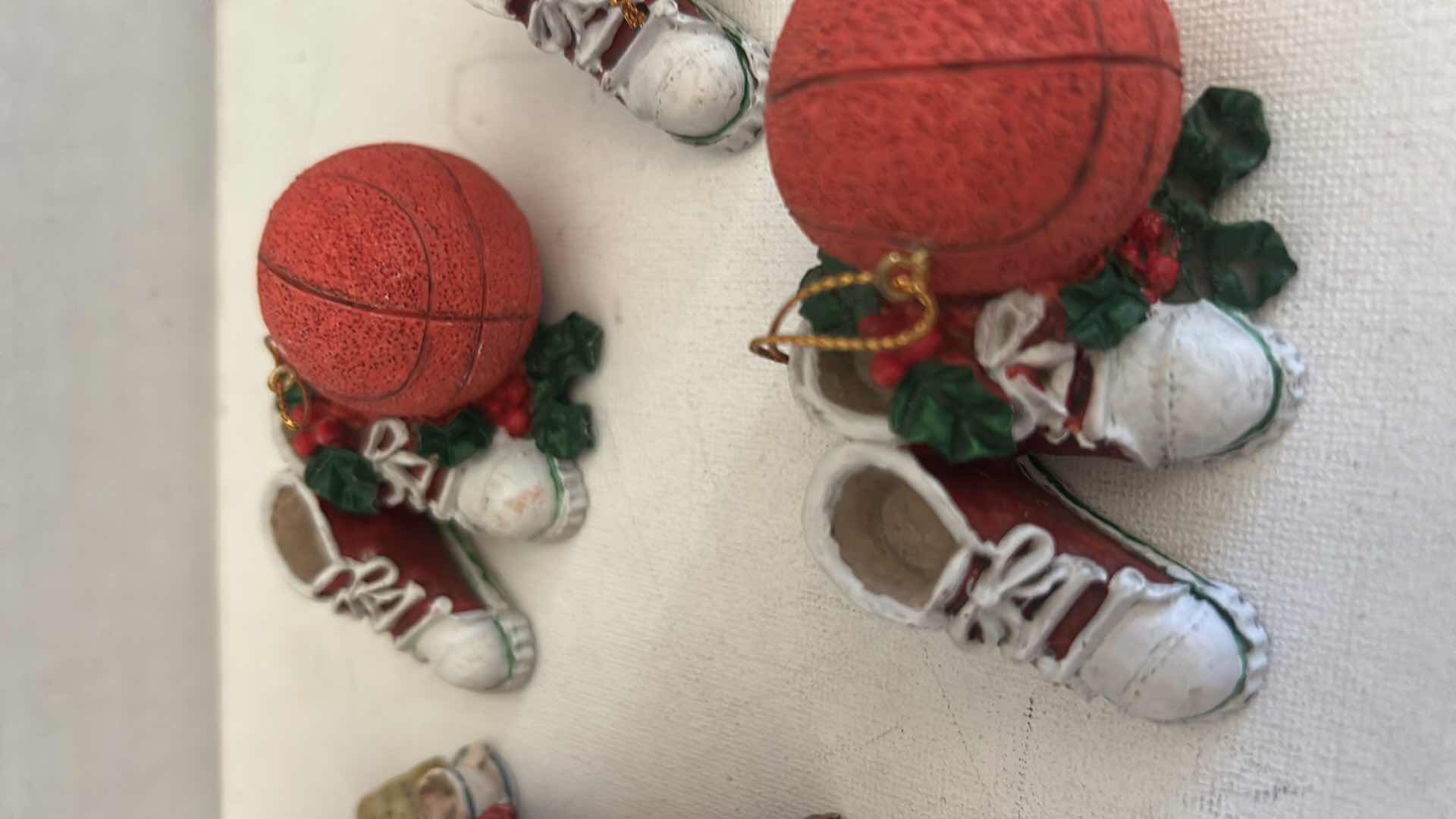 Photo 1 of FOUR BASKETBALL ORNAMENTS, GLASS, PORCUPINE & CERAMIC FIGURINE OF CAT IN BED H2.5”