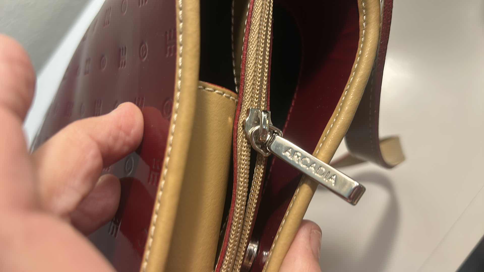 Photo 1 of ARCADIA BURGUNDY EMBOSSED MONOGRAM PATENT LEATHER BUCKET BAG