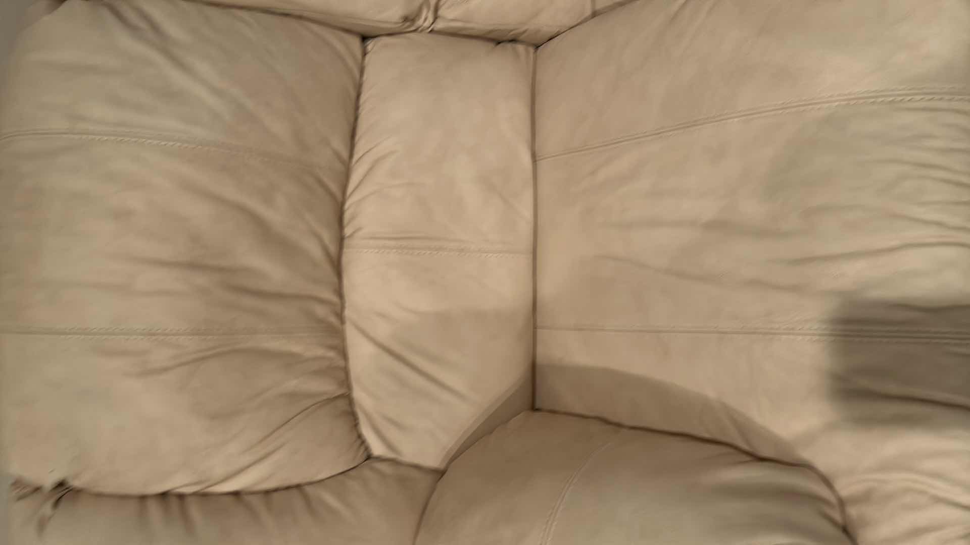 Photo 1 of OFF WHITE LEATHER RECLINING LOVESEAT W COMFORTABLE PADDED CUSHIONS W DIAGONAL SEAM DETAIL 2 ACCENT PILLOWS