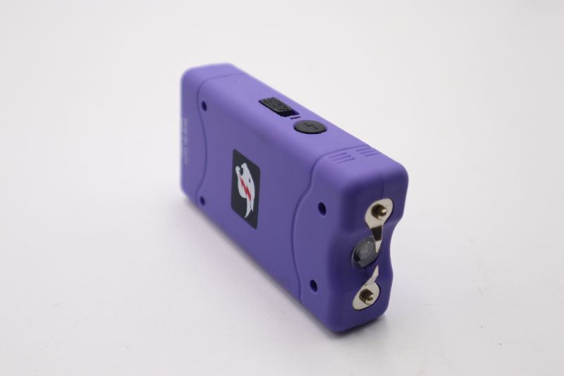 Photo 1 of 4 x 2 INCH PURPLE MINI STUN GUN AND FLASHLIGHT WITH CARRYING CASE ABLE TO LOOP ONTO BELT NEW