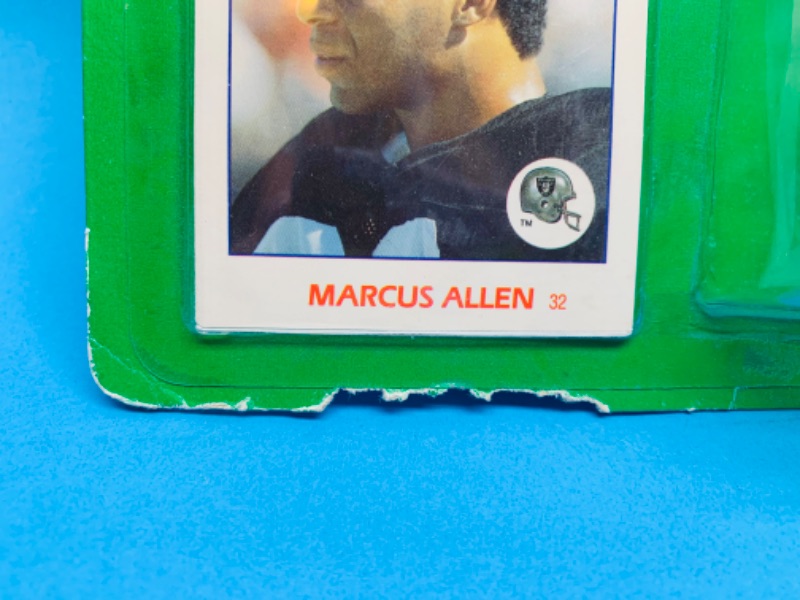Photo 1 of 257764…starting line up Marcus Allen football figure- damage on bottom corner of pkg 