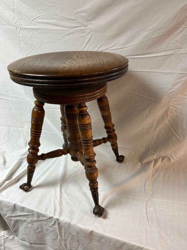 Photo 1 of Antique swivel oak piano stool with claw feet and glass balls