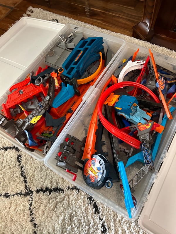 Photo 1 of 2 plastic bins with hot wheels tracks and a few cars 