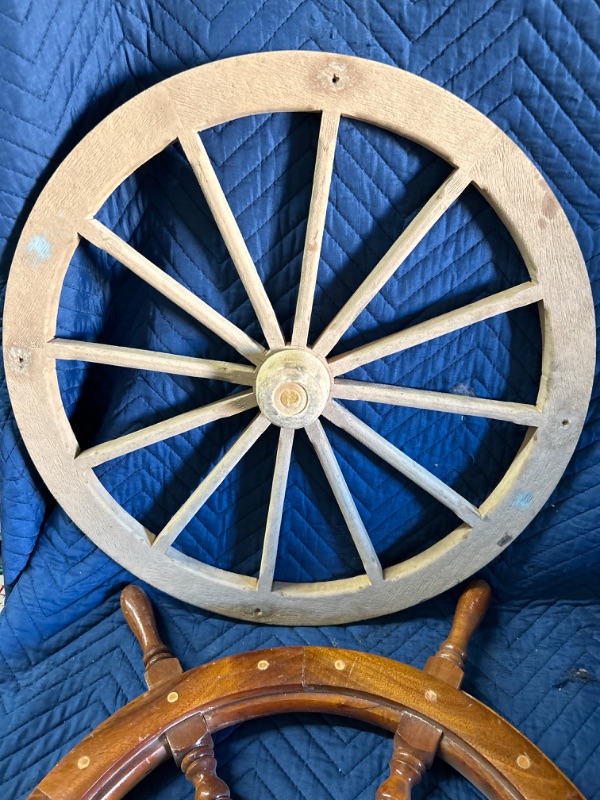 Photo 3 of Wood and brass ships wheel has broken handle that is included also includes wall hanging of wagon wheel 