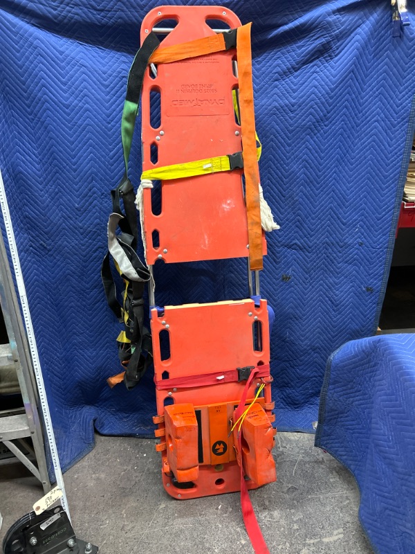 Photo 1 of Dynamed dolphin II spine board with straps center of board has been cut to accommodate a gymnastic harness