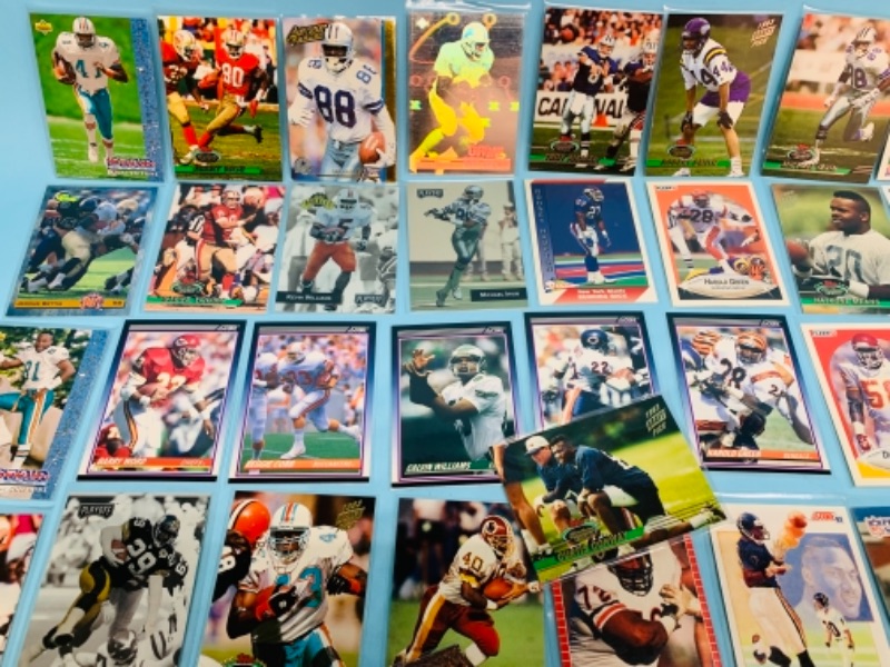 Photo 6 of 277958…75 mixed football trading cards in plastic sleeves 