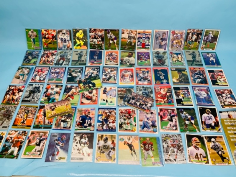 Photo 1 of 277958…75 mixed football trading cards in plastic sleeves 