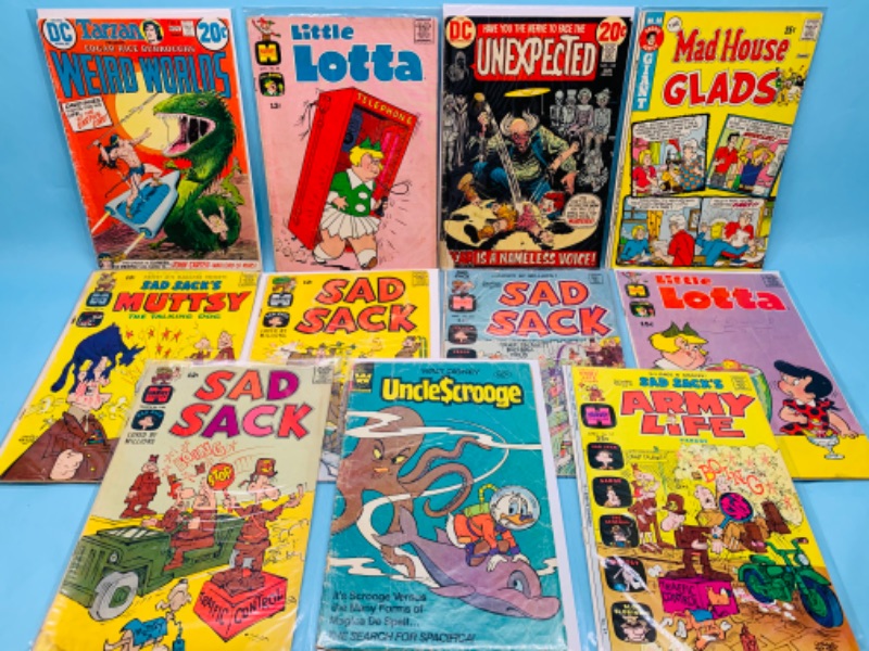 Photo 1 of 278064…11 vintage comics in sleeves- shows wear from age- tares and bends