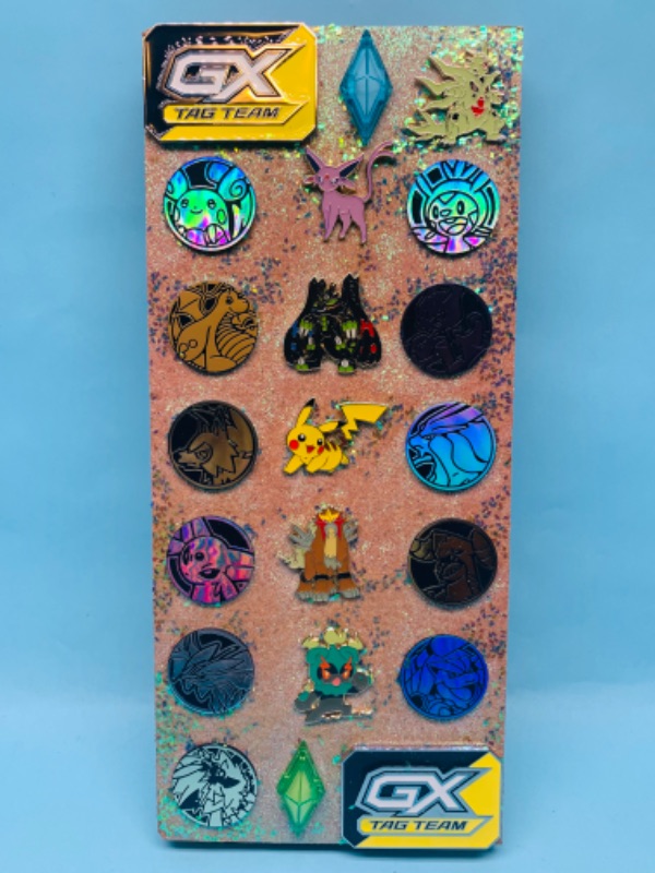 Photo 1 of 278140… collectible Pokémon pins and pogs on a cork board 
