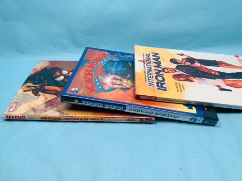 Photo 2 of 278910…3 hardcover books- wonder woman, spider woman, and Iron Man in plastic sleeves