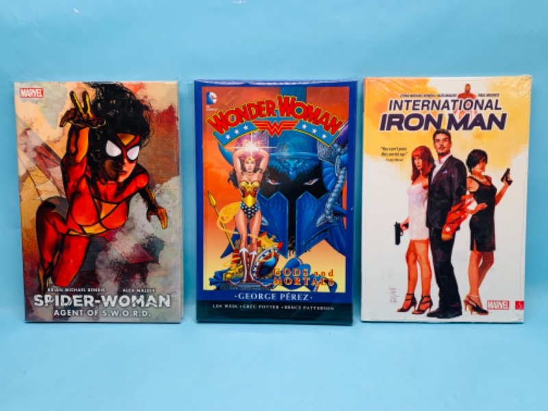 Photo 3 of 278910…3 hardcover books- wonder woman, spider woman, and Iron Man in plastic sleeves