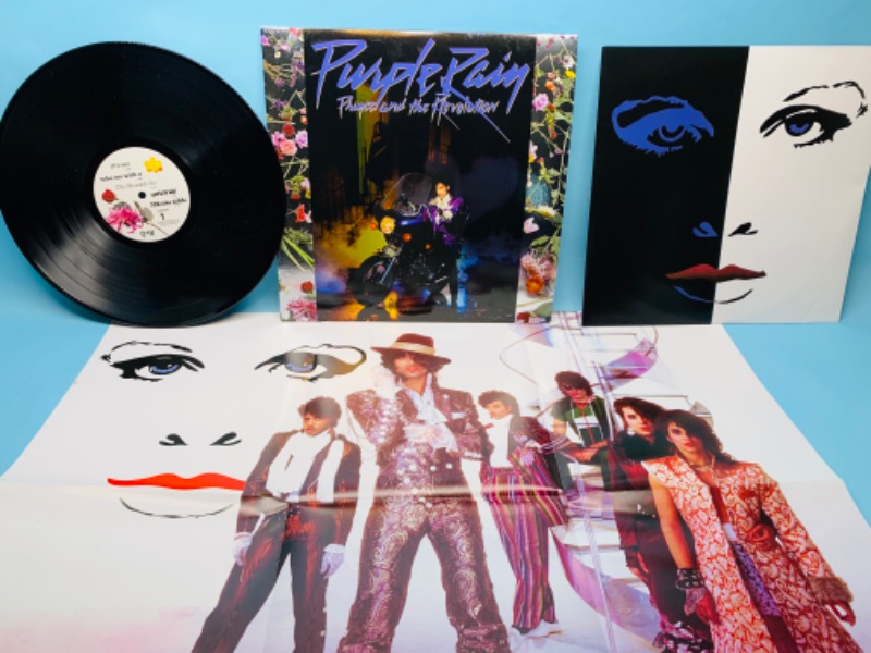 Photo 2 of 279381… great condition Prince Purple Rain vinyl record with poster in plastic sleeve cover and record in great condition 