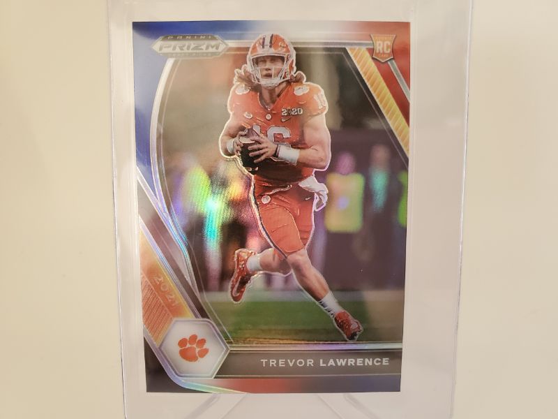 Photo 1 of 2021 PANINI PRIZM RED/WHITE/BLUE TREVOR LAWRENCE ROOKIE!!
THIS CARD IS IMMACULATE AND GET IT GRADED FAST!!