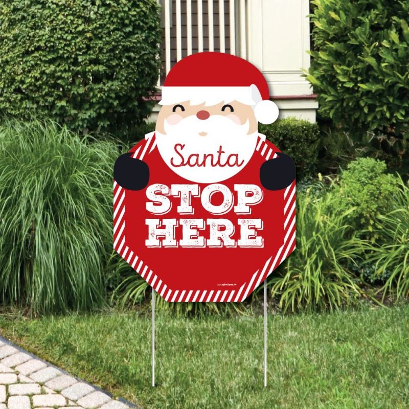 Photo 1 of Big Dot of Happiness Jolly Santa Claus - Santa Stop Here Yard Sign - Christmas Welcome Yard Sign