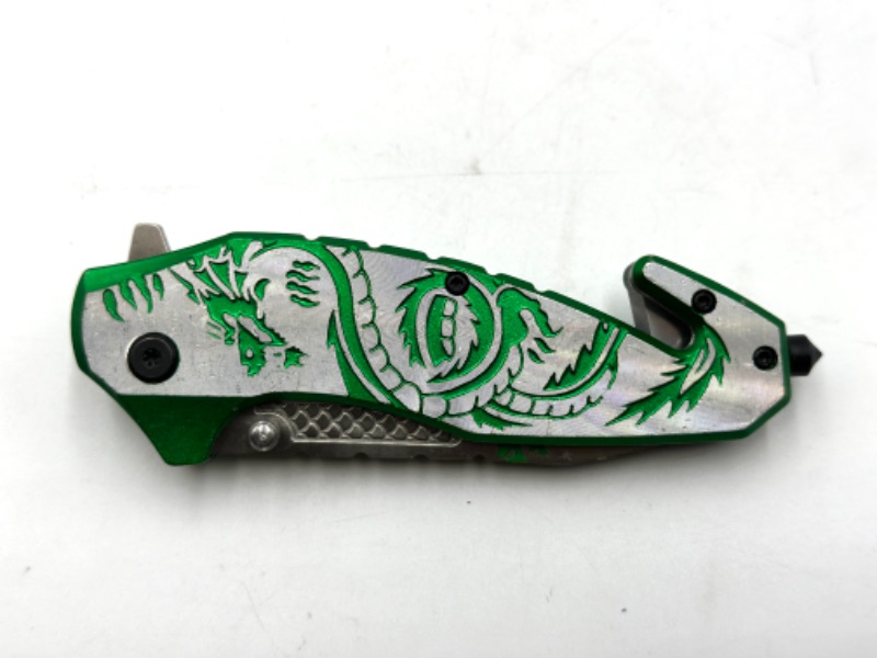 Photo 1 of GREEN DETAILED POCKET KNIFE WITH WINDOW BREAKER AND SEAT BELT CUTTER NEW