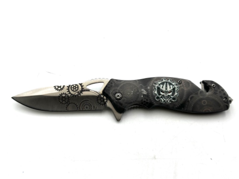 Photo 1 of SKULL AND MACHINERY DESIGN POCKET KNIFE WITH WINDOW BREAKER KEYCHAIN LOOP AND SEAT BELT CUTTER NEW