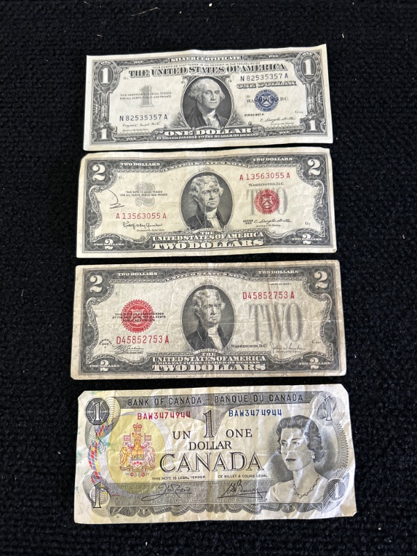 Photo 1 of Vintage money includes 1957A silver certificate 1963 and 1928 $2 bills and 1973 Canadian dollar 