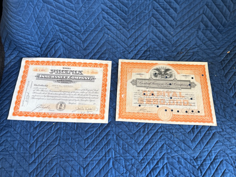 Photo 1 of two  stock certificates central Farmers trust 1925 and Phoenix Insurance 1954 