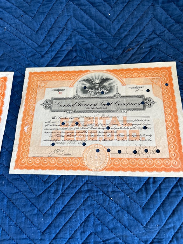 Photo 3 of two  stock certificates central Farmers trust 1925 and Phoenix Insurance 1954 