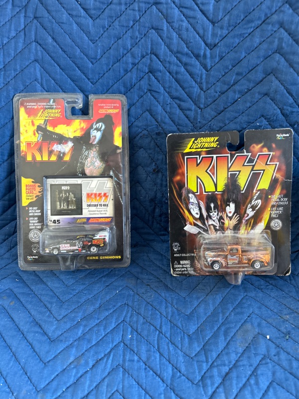 Photo 1 of Two Johnny Lightning Kiss toy cars in packaging 