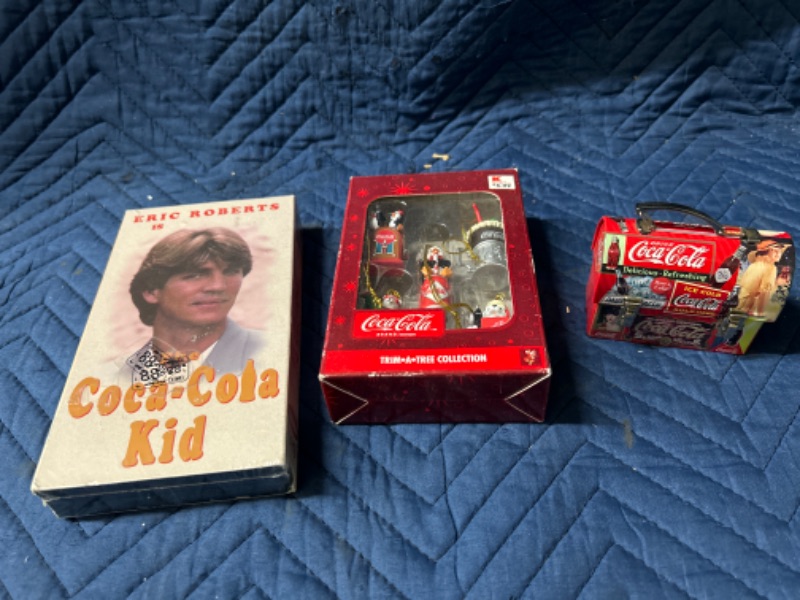 Photo 1 of Coca Cola items including mini ornaments, Lunchbox and Coca Cola Kid VHS sealed 