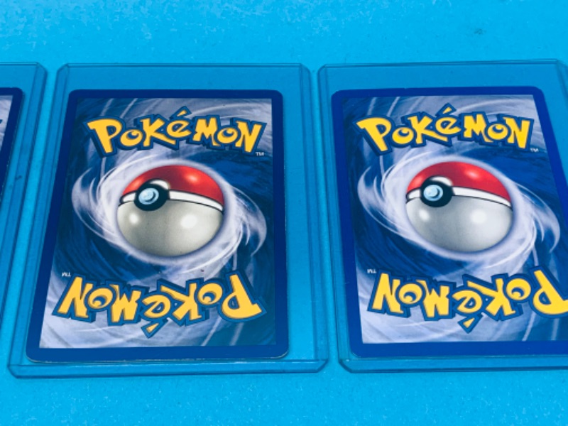 Photo 2 of 462491…4 Pokémon holo cards -corners show wear- in hard sleeves dates 1999-2000