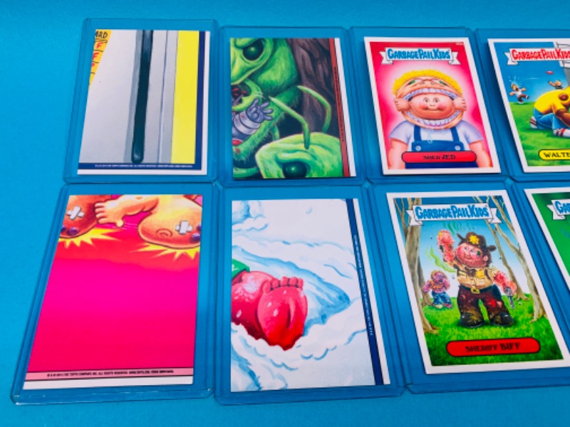 Photo 2 of 462495… 8 garbage pail kids cards in hard sleeves with puzzle on back sides