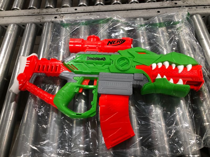 Photo 2 of NERF DinoSquad Rex-Rampage Motorized Dart Blaster, 10-Dart Clip, 20 Official Darts, 10-Dart Storage- T-Rex Dinosaur Design , Red
